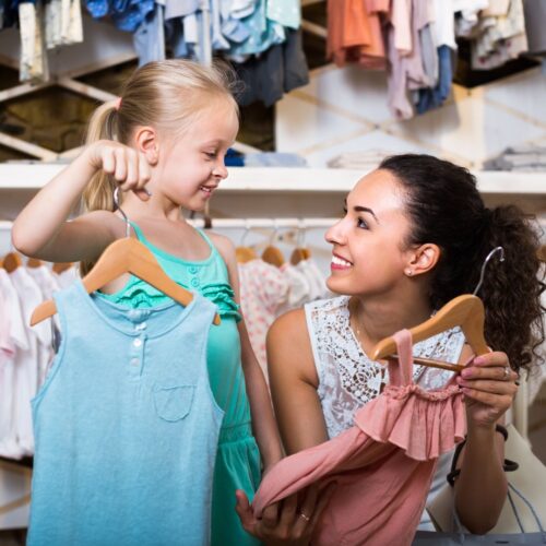 mom shopping for preschool clothes with daughter