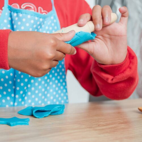 image of a kid using play dough